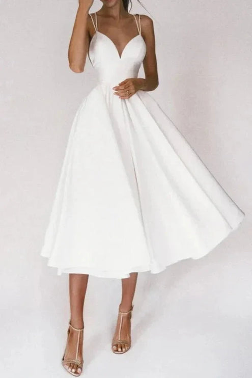 White V neck midi dress with thin straps and flared skirt for wedding guest
