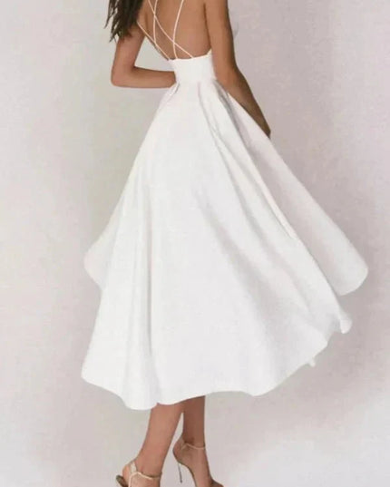 White backless midi dress with flowing skirt and crisscross straps