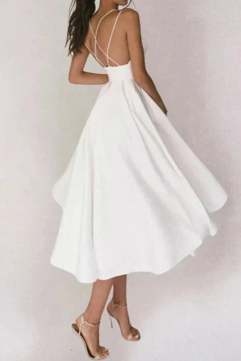 White backless midi dress with flowing skirt and crisscross straps