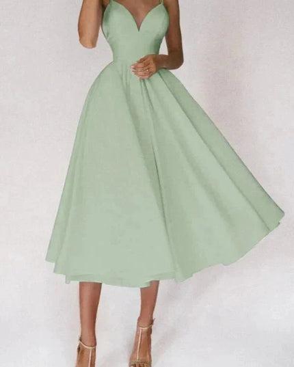 Mint green open back midi dress with crisscross straps and wide flowing skirt