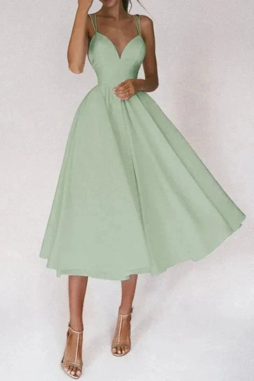 Mint green open back midi dress with crisscross straps and wide flowing skirt