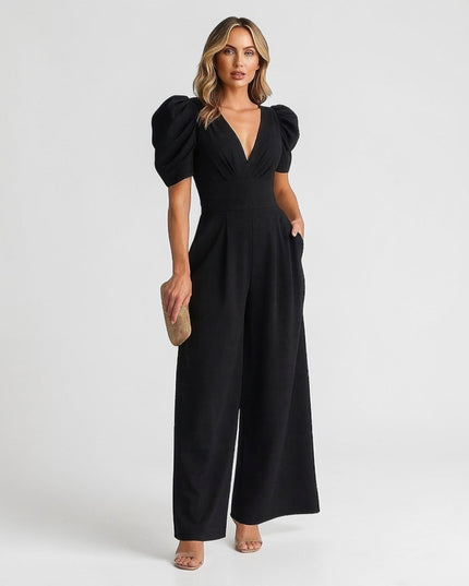 Black wide leg jumpsuit with puff sleeves, deep V-neck, and tailored waist