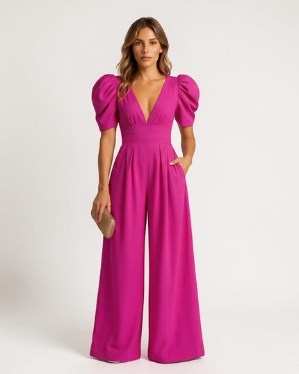 Magenta wide leg jumpsuit with puff sleeves, deep V-neck, and flowing legs