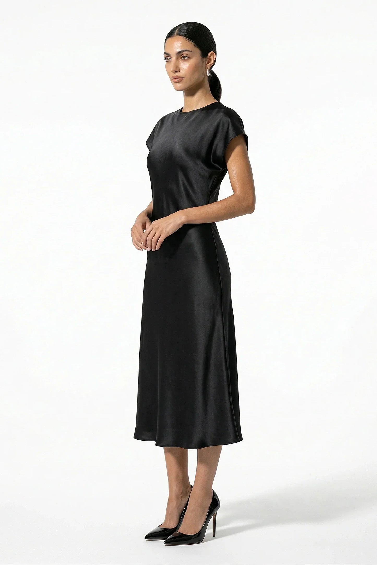 Side view of black satin midi dress with cap sleeves and midi length
