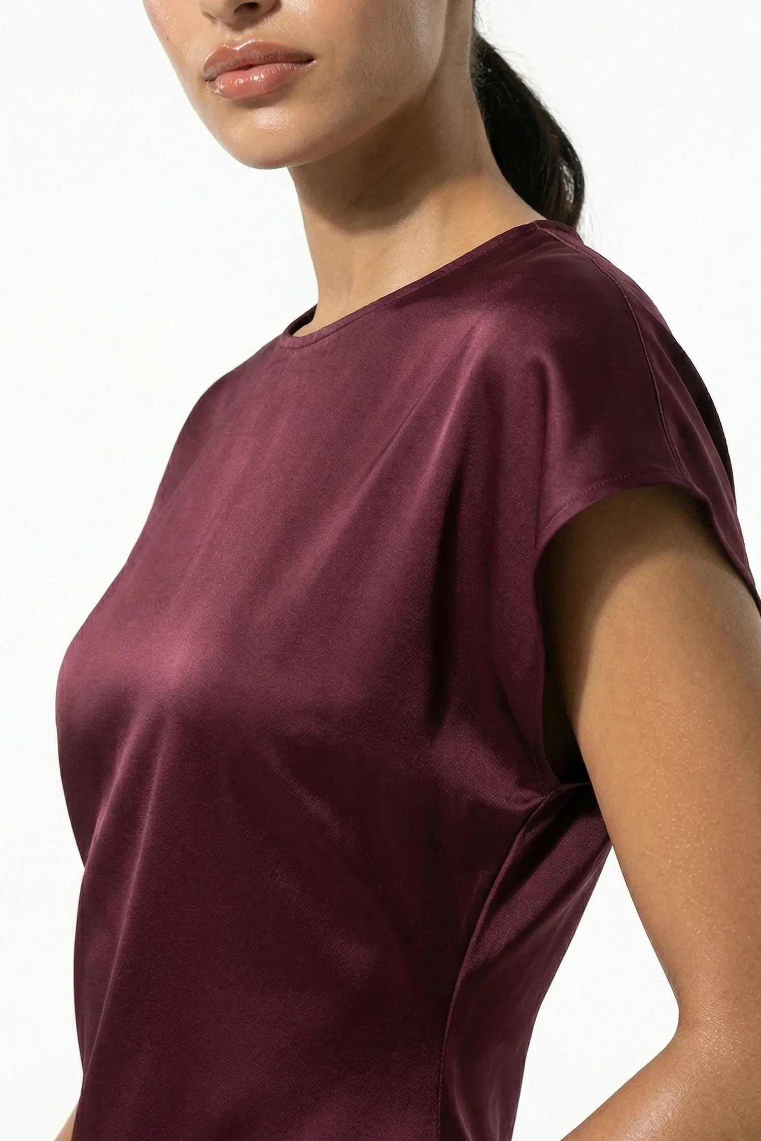 Close-up of burgundy satin midi dress showing sheen and cap sleeve detail