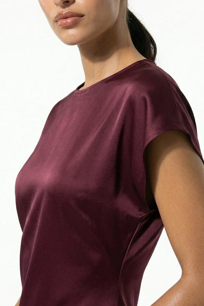 Close-up of burgundy satin midi dress showing sheen and cap sleeve detail
