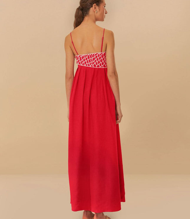Back view of red fish print maxi dress with open back and scalloped waistband detail