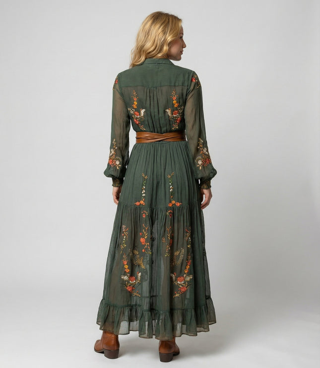Back view of green floral maxi dress with long sheer sleeves, pleated skirt, and waist belt
