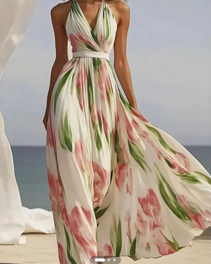 Cream floral halter maxi dress with pink and green print, fitted waist and full flowing skirt