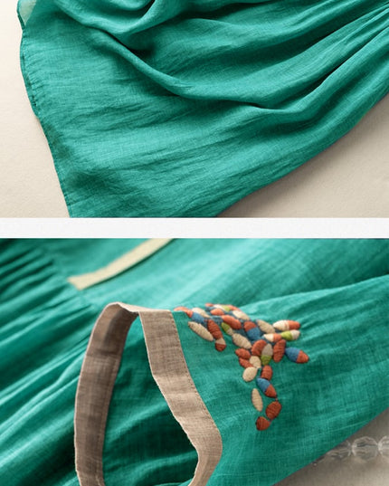 Close-up of teal summer dress showing embroidered sleeve cuff and lightweight fabric texture