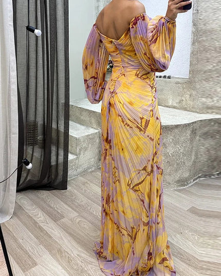 Back view of floral off shoulder maxi dress with long puff sleeves and flowing skirt
