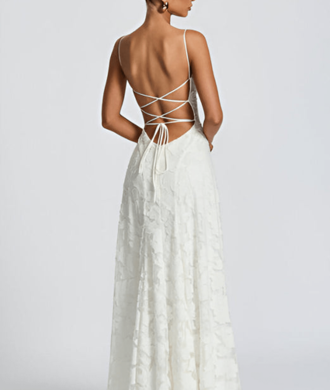 Back view of white floral maxi dress with open back and crisscross tie detail