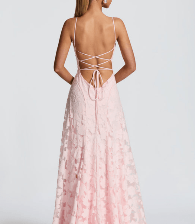 Back view of light pink floral maxi dress with open back and crisscross tie straps