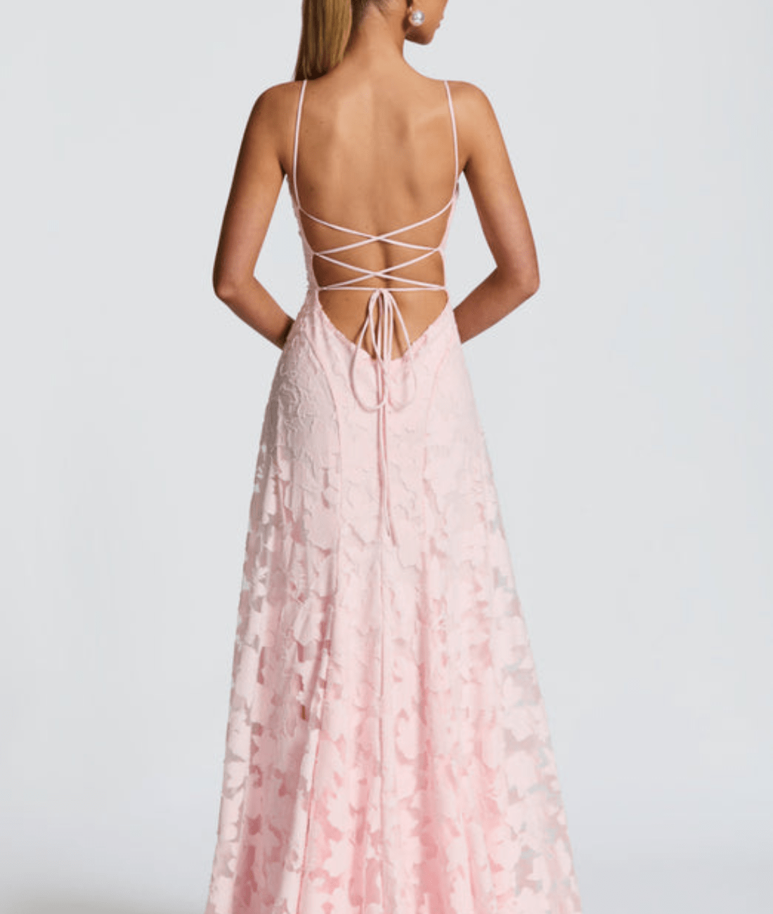 Back view of light pink floral maxi dress with open back and crisscross tie straps