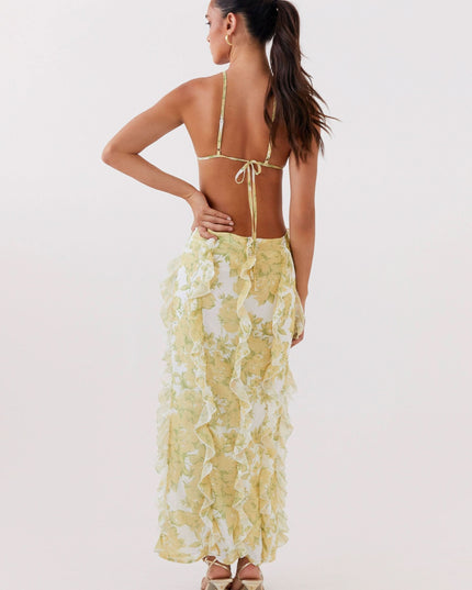 Back view of women's floral maxi dress with low open back, tie straps, and layered ruffles