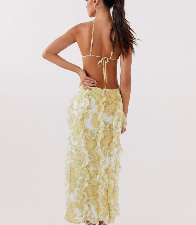 Back view of women's floral maxi dress with low open back, tie straps, and layered ruffles