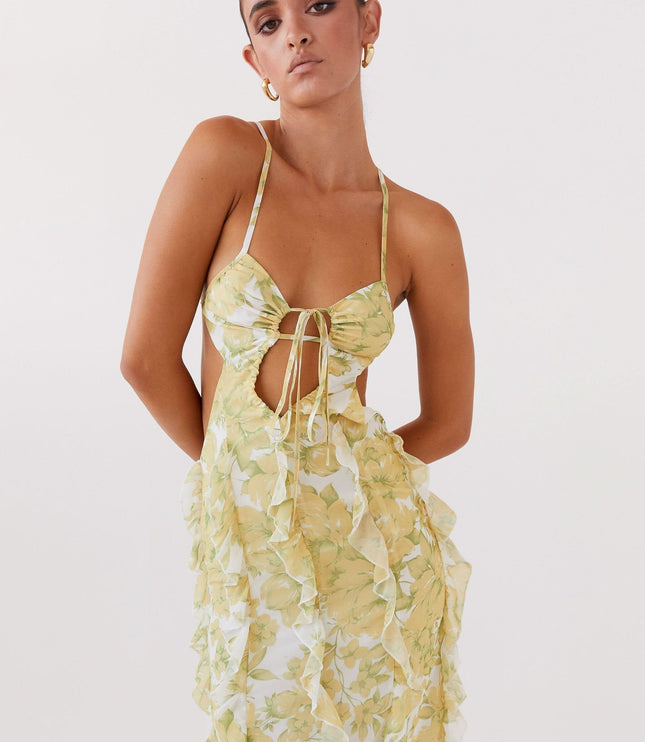 Close-up of floral maxi dress bodice with tie front, cutout detail, and delicate spaghetti straps