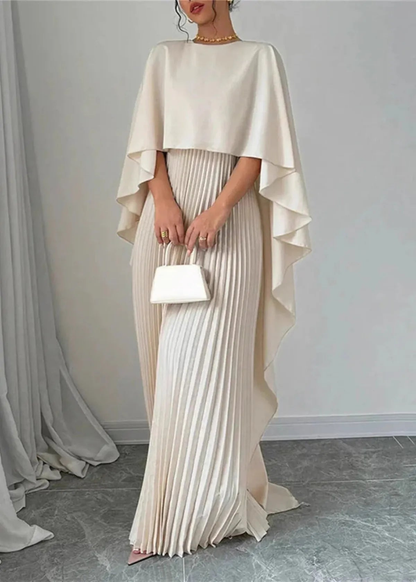 Front view of cream formal maxi dress with cape overlay, pleated skirt, and clutch