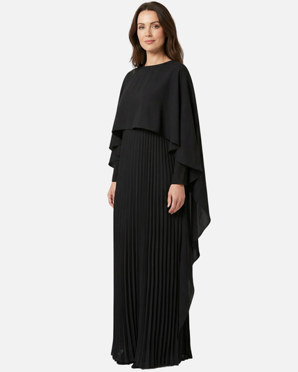 Front view of black cape overlay maxi dress with long pleated skirt for formal wear