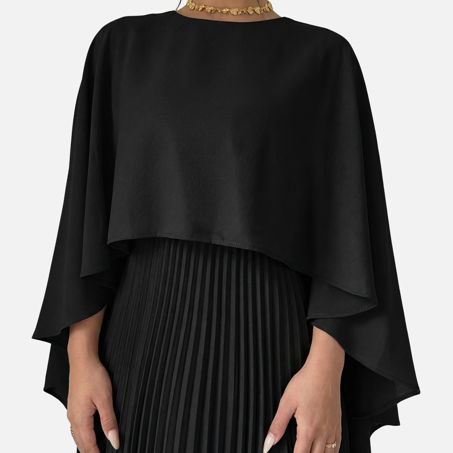 Close-up of black cape overlay maxi dress with pleated skirt and draped formal top