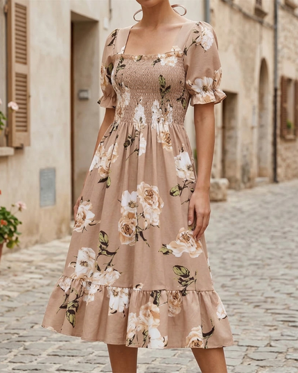 Beige floral midi dress with square neck, puff sleeves, and smocked bodice on a model