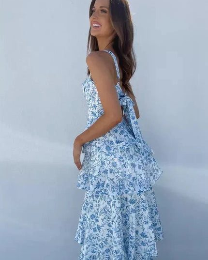 Back view of a floral tiered maxi dress with tie straps and flowing ruffle layers