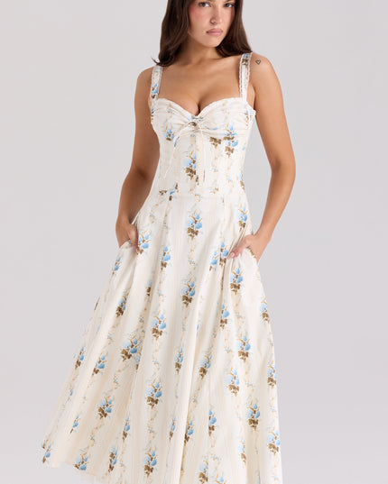 Front view of cream floral sweetheart midi dress with blue flowers and side pockets