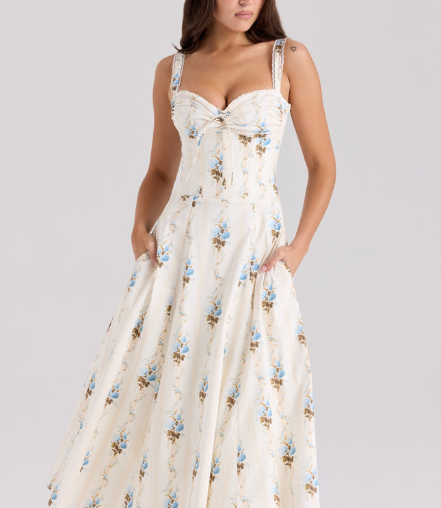 Front view of cream floral sweetheart midi dress with blue flowers and side pockets