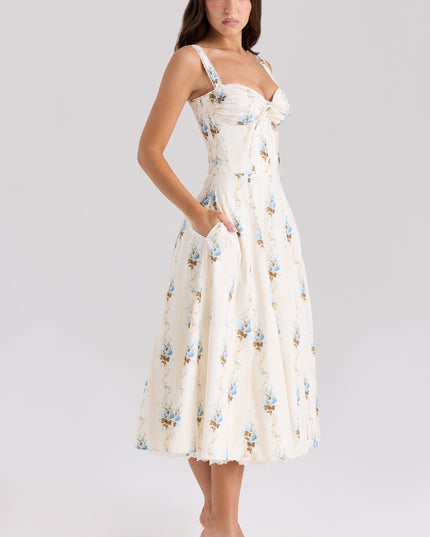 Three-quarter back view of cream floral midi dress with fitted bodice and flared skirt