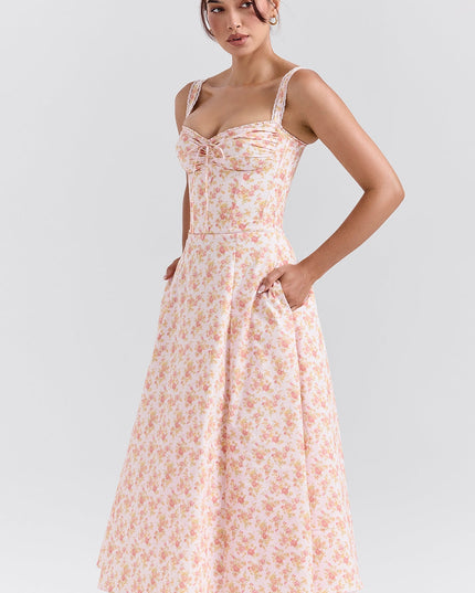 Side angle of pink floral midi dress with sweetheart neckline and fitted bodice for wedding guest outfit