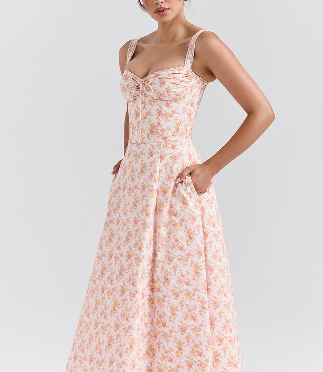 Side angle of pink floral midi dress with sweetheart neckline and fitted bodice for wedding guest outfit