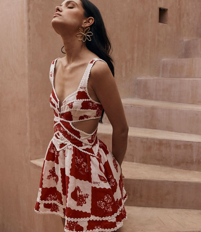 Back view of a red and white floral mini dress with cutout sides and wide straps