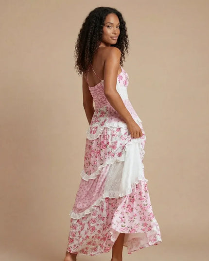 Back view of pink floral maxi dress showing open back and layered ruffled hem detail