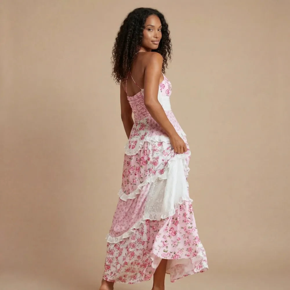 Back view of pink floral maxi dress showing open back and layered ruffled hem detail