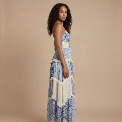 Blue floral v-neck maxi dress with cream waistband and asymmetrical tiered ruffle layers