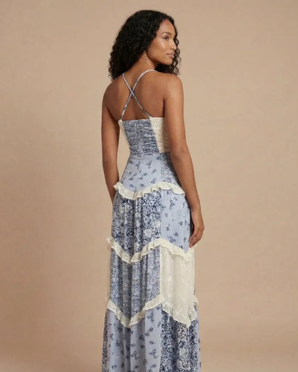 Back view of blue floral maxi dress with crisscross straps and cream ruffled tier details