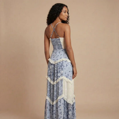 Back view of blue floral maxi dress with crisscross straps and cream ruffled tier details