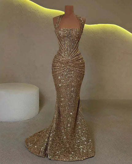 Gold sequin halter maxi dress on mannequin, ruched waist and floor-length mermaid hem
