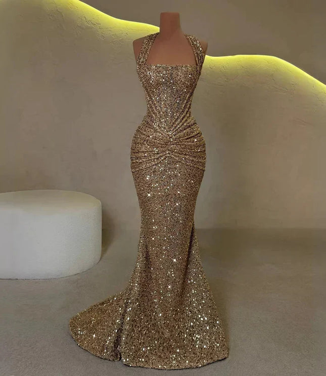 Gold sequin halter maxi dress on mannequin, ruched waist and floor-length mermaid hem