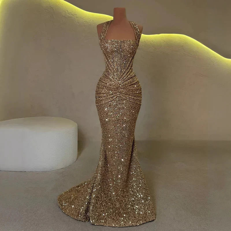 Gold sequin halter maxi dress on mannequin, ruched waist and floor-length mermaid hem