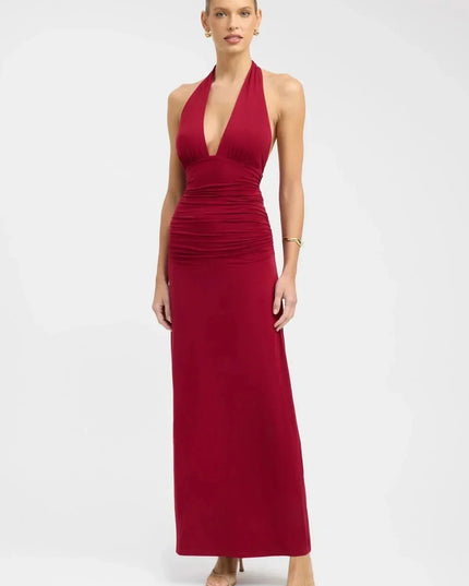 Front view of burgundy formal maxi halter dress with deep V neckline and ruched waist