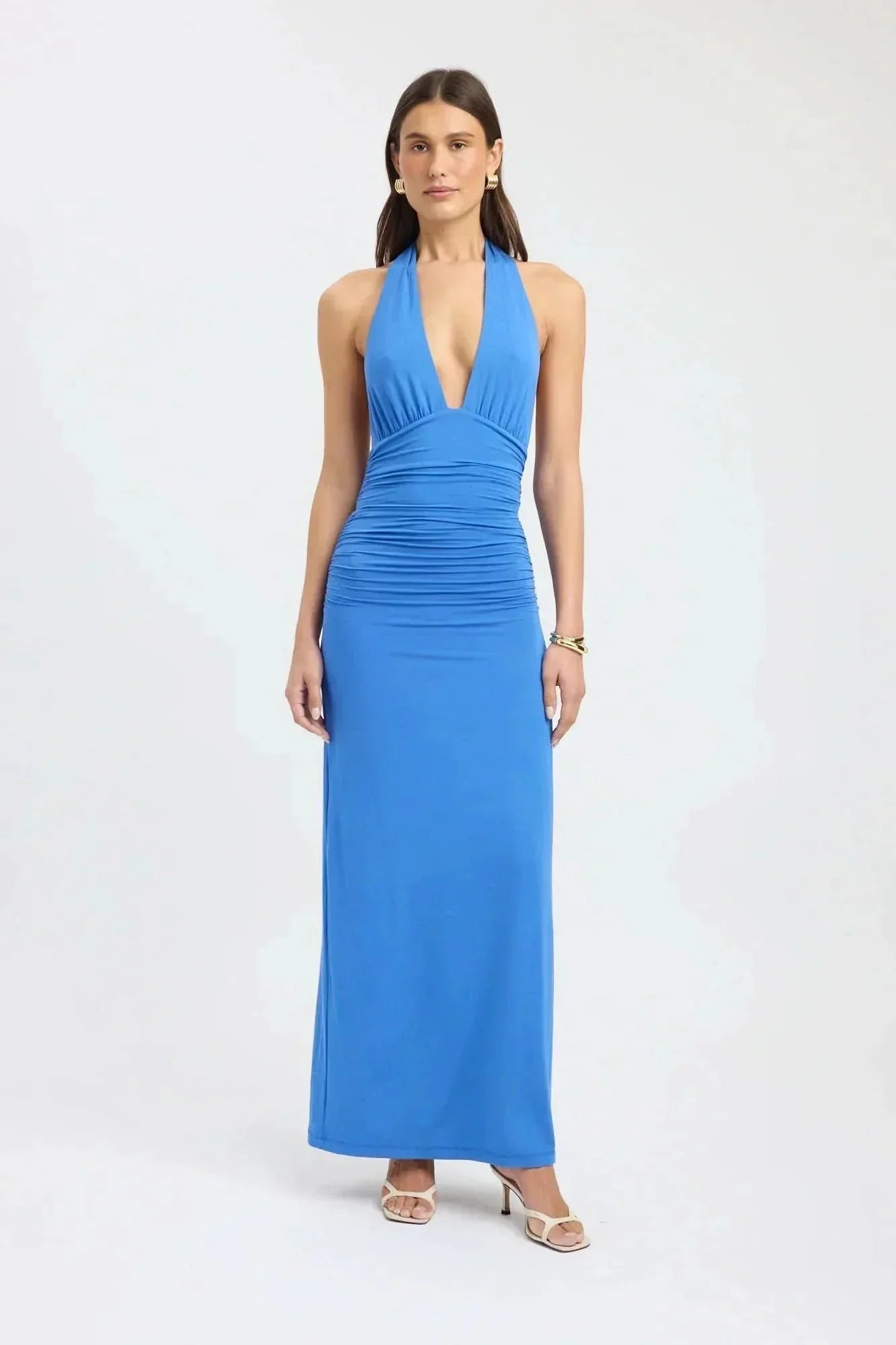 Back view of pale yellow formal maxi halter dress with open back and tie waist