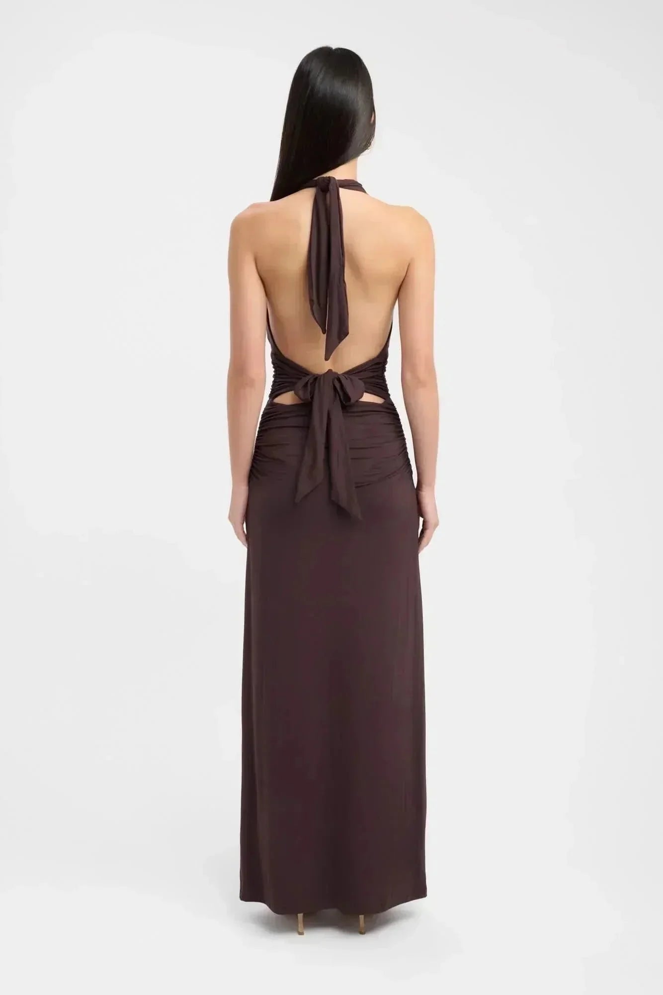 Back view of a dark brown formal maxi dress with open back and tie halter straps