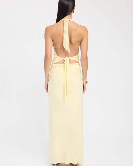 Back view of pale yellow formal maxi halter dress with open back and tie waist