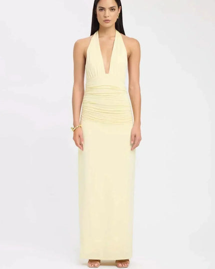Back view of black formal maxi halter dress with open back and draped tie detail
