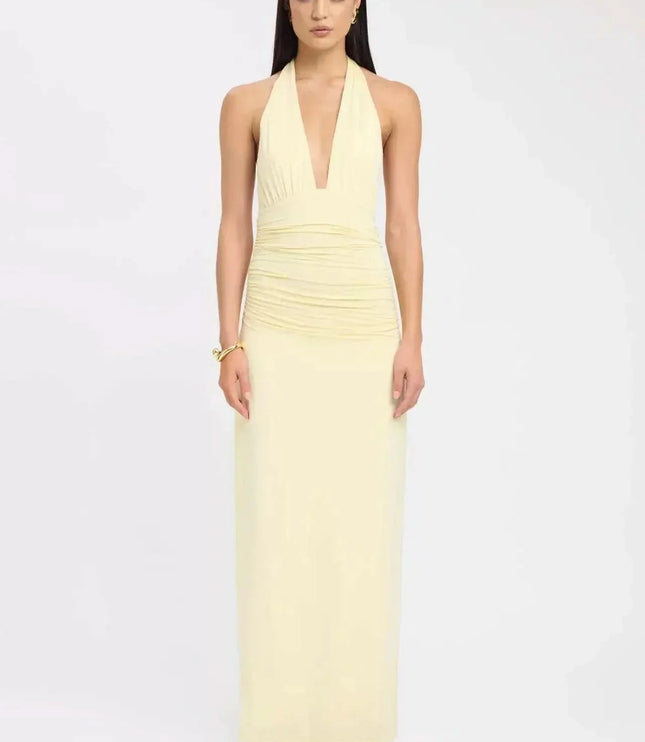 Front view of pale yellow formal maxi halter dress with plunging neckline and fitted skirt