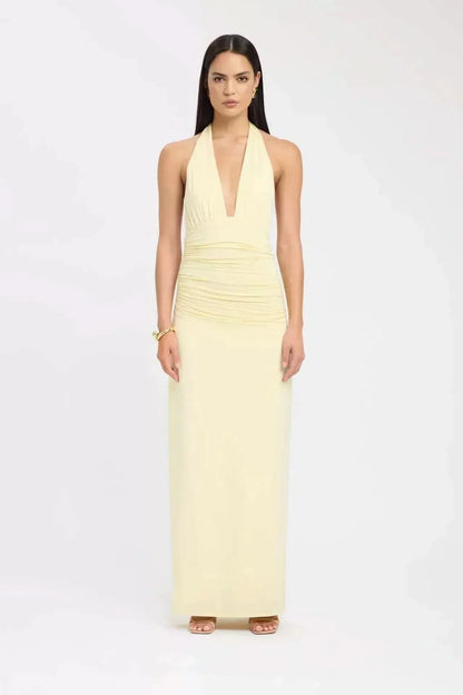 Front view of pale yellow formal maxi halter dress with plunging neckline and fitted skirt