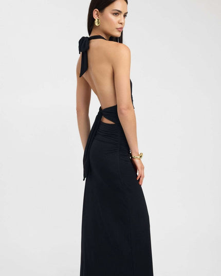 Back view of black formal maxi halter dress with low open back and long tie sash