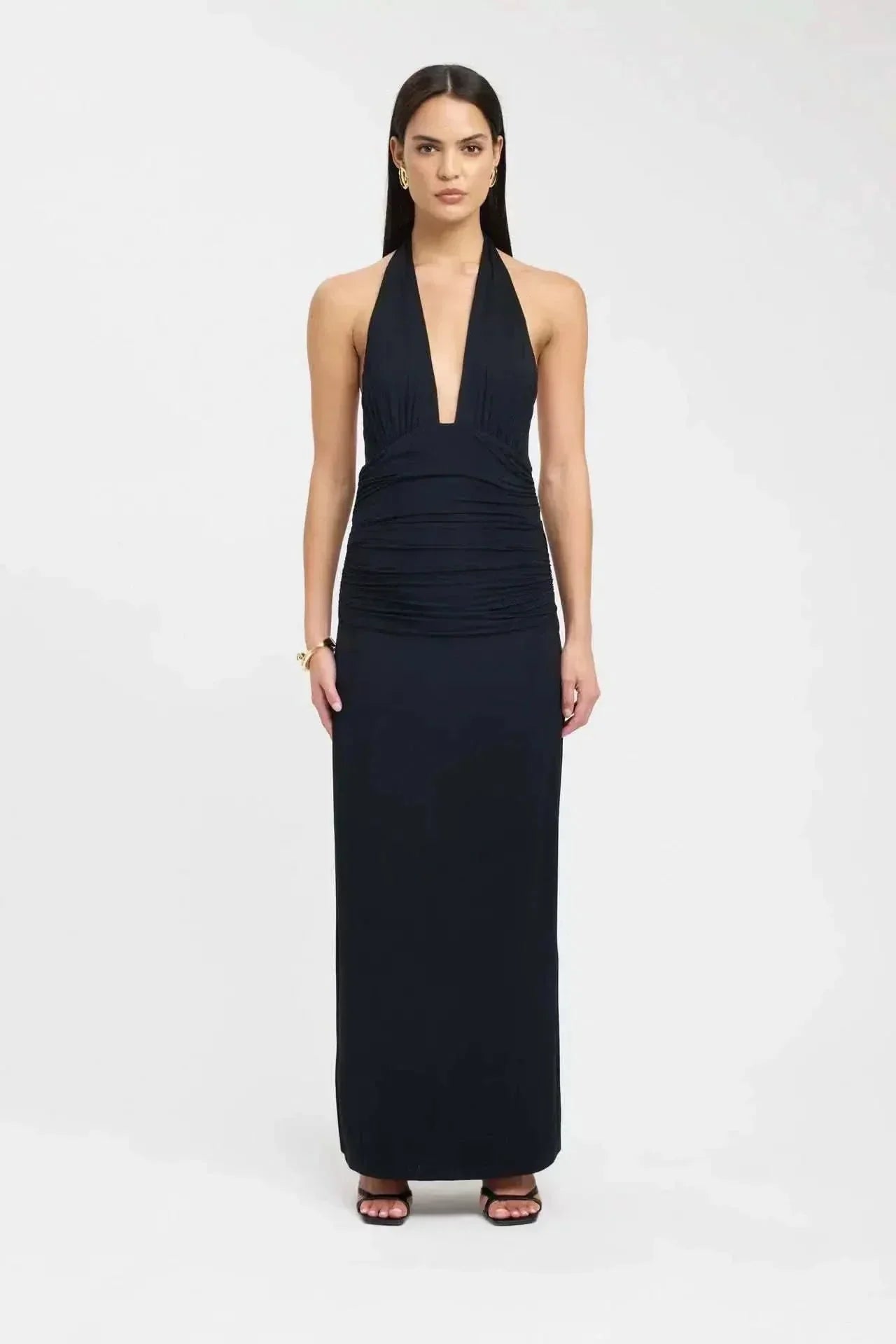 Front view of a black halter top maxi dress with deep plunge neckline and ruched bodice
