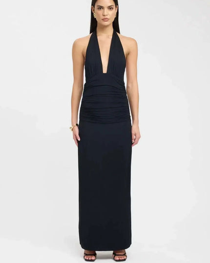 Back view of a black maxi dress with open back, tie waist detail, and long skirt